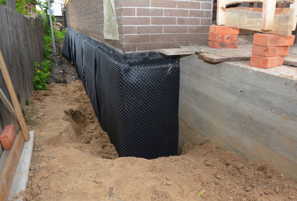 SJ Waterproofing Pros technician performing targeted Emergency Waterproofing assessment in Trafalgar, IN